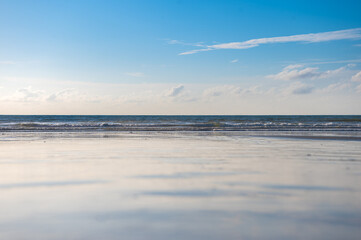 Reflection of beach and blue sky.