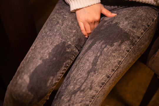 Low Section View Of Person's Wet Jeans Standing On Carpet.