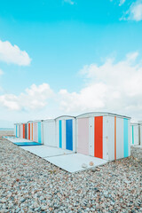 Fototapeta na wymiar Small houses or beach cabins of different colors on the beach of Le Havre in France