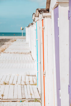 Small houses or beach cabins of different colors on the beach of Le Havre in France