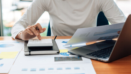 Close up of accountant or banker checking investment results, calculates financial savings,...