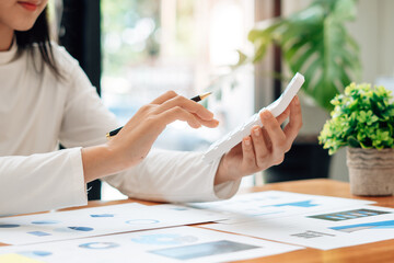 Close up of accountant or banker checking investment results, calculates financial savings, calculates annual taxes and economic concepts. Financial calculation concept.