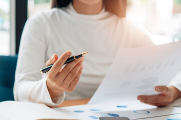 Close up view of bookkeeper or financial inspector hands making report, calculating or checking balance. Home finances, investment, economy, saving money or insurance concept.