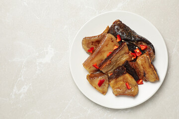 Tasty fried pork lard with pepper on light table, top view. Space for text