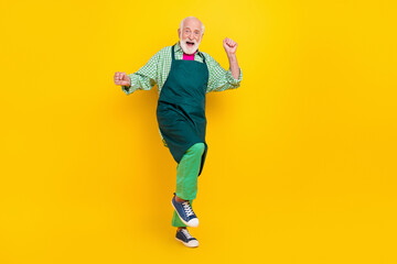 Fototapeta na wymiar Full length body size view of attractive cheerful man barber dancing having fun isolated over bright yellow color background
