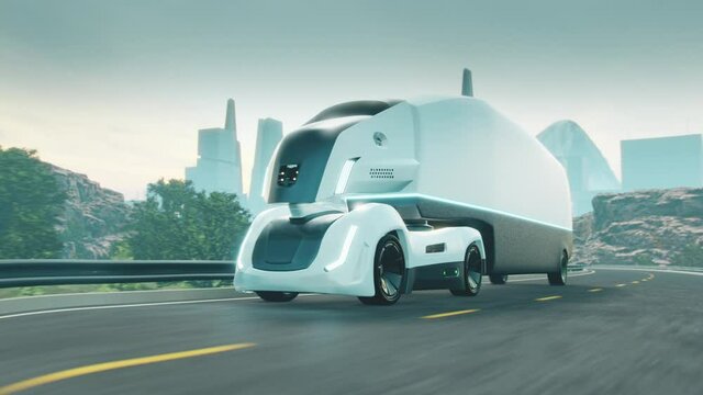 Futuristic driverless electric truck on highway. City on the background.