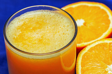Fresh squeezed orange juice in glass and orange