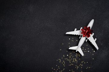 Toy white airplane with golden stars. Christmas concept of travel and delivery by plane, New Year