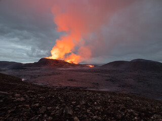 Night volcanic eruption. Fresh hot lava and poisonous gases going out from the crater.
