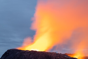 Night volcanic eruption. Fresh hot lava, flames and poisonous gases going out from the crater.