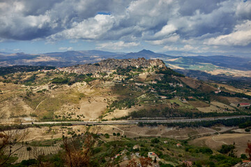 Fototapeta premium the town of Calascibetta seen from Enna in Sicily on a cloudy day at the end of summer