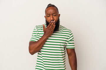 African american man with beard isolated on pink background yawning showing a tired gesture covering mouth with hand.