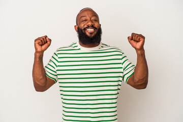 African american man with beard isolated on pink background celebrating a victory, passion and enthusiasm, happy expression.