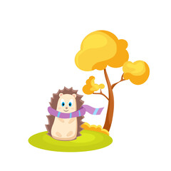 In deep autumn, a hedgehog, wrapped in a scarf, stands under a tree