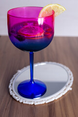 glass of wine on blue background