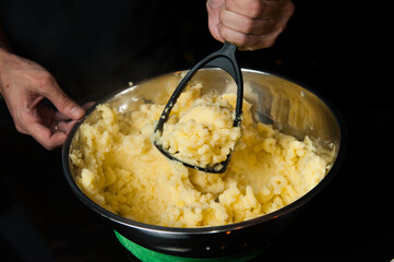 close of hand preparing the mashed potatoes horizon shot