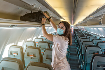 woman in medical mask in plane