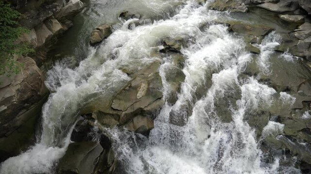 Snaky crystalline streams moving down a waterfall in the Carpathian mountains  