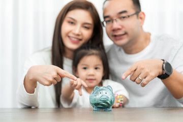 family savings, budget planning, children's pocket money.Asian family mother farther and daughter show piggy bank moneybox