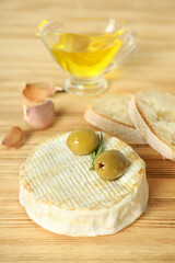 Concept of tasty food with grilled camembert on wooden background