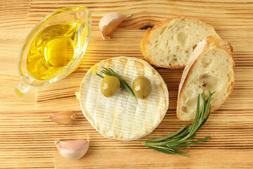 Concept of tasty food with grilled camembert on wooden background