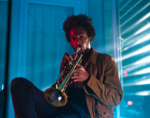 Young trumpeter performs at home