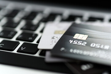 Close up shot of credit card on Laptop computer payment for purchases from online stores and online shopping. Concept of internet purchase. Selective focus for background.