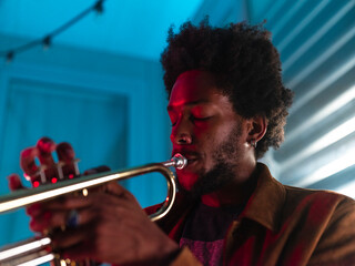 Young trumpeter performs at home