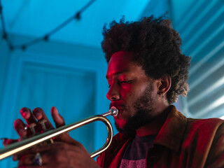 Young trumpeter performs at home