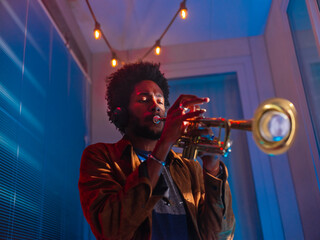 Young trumpeter performs at home