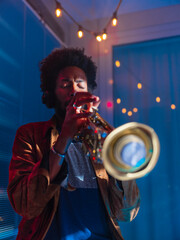 Young trumpeter performs at home