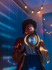 Young trumpeter performs at home