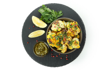 Tray with baked cauliflower and spices isolated on white background