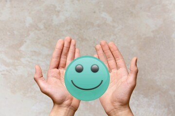 Hands holding happy smile face, good feedback rating and positive customer review