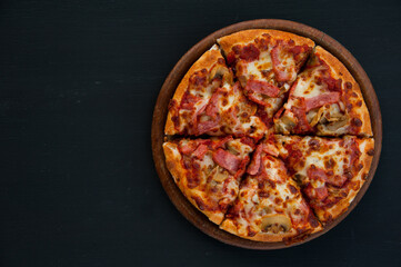 Top view of pizza isolated on black, right frame with copy space