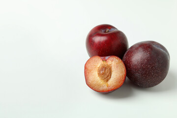 Plums with a half on a white background
