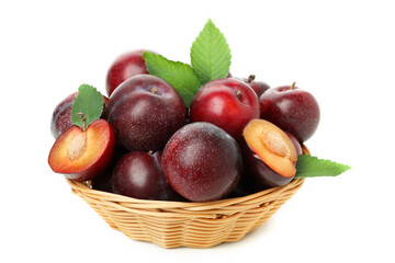 Plums in bowl isolated on white background, close up