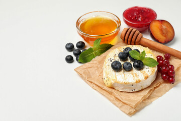Concept of tasty food with grilled camembert on white background
