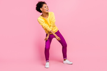 Fototapeta na wymiar Photo of pretty adorable lady wear yellow pullover dancing smiling isolated pink color background