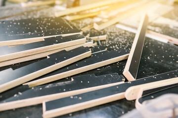 Wooden parts on the table. Carpentry workshop for the production of furniture. Wooden blanks on a workbench with your own hands. Close-up details. Craft hobby