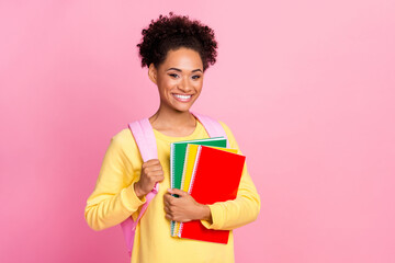 Photo of pretty attractive lady wear yellow pullover backpack holding diaries empty space isolated pink color background