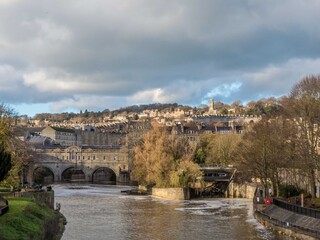 Naklejka premium the picturesque horseshoe weir at Pulteney Bridge built in the 1600s to prevent flooding in Bath Somerset England