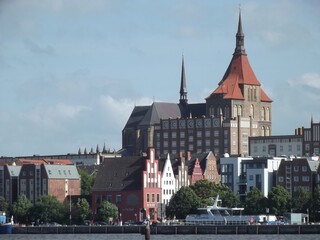 Obraz premium The Marienkirche in Rostock, Mecklenburg-Western Pomerania, Germany, seen across Warnow river