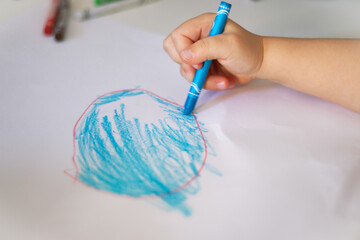 child draws paints with pencil