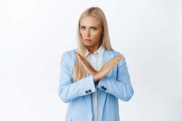 Serious business woman makes cross with arms, decline smth bad, reject offer, prohibit or telling...