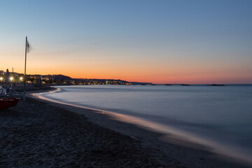 Sunset in Italy over the ocean. Nice warm colors and sandy beach.