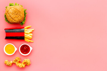 Junk fat food snack - french fries and burger, top view