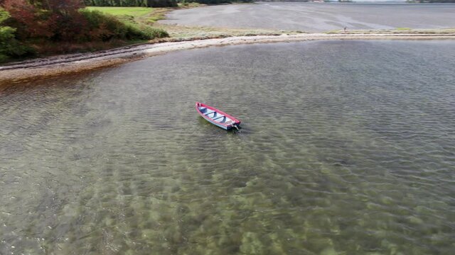 Drone Fly Around a Small Motorboat Lying at Anchor Off the Coast