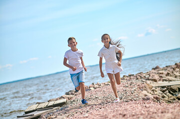 Two kinds running on a beach and feeling great