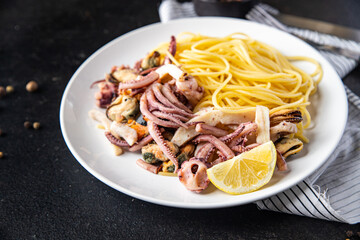 spaghetti seafood pasta mussel, squid, octopus, shrimp fresh portion ready to eat meal snack on the table copy space food background rustic. top view  vegetarian food pescetarian diet